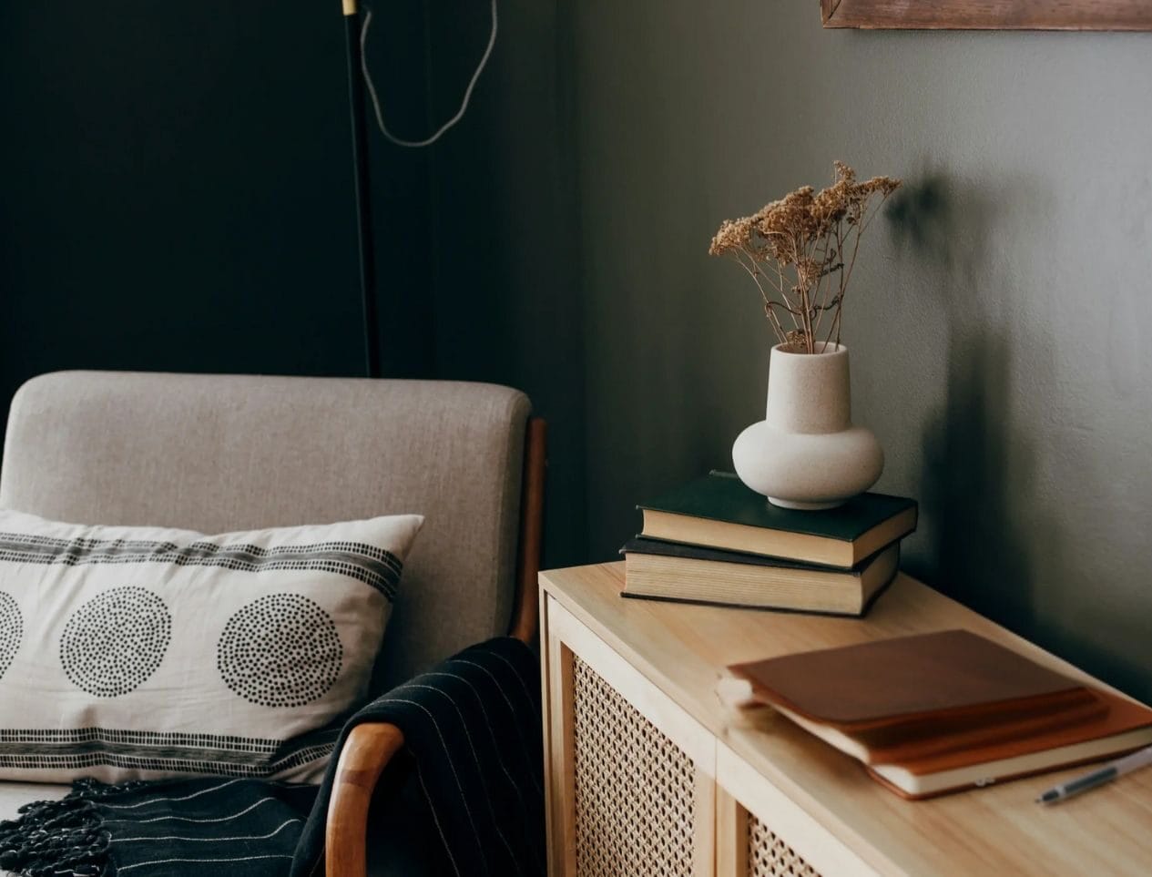 A neutral-toned living room corner in Connecticut with a cushioned chair, books, and calming decor—an inviting space perfect for rediscovered psychiatry and peaceful reflection.